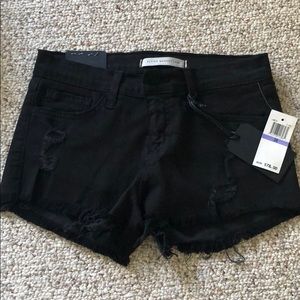 Size 26 black flying monkey distressed shorts.
